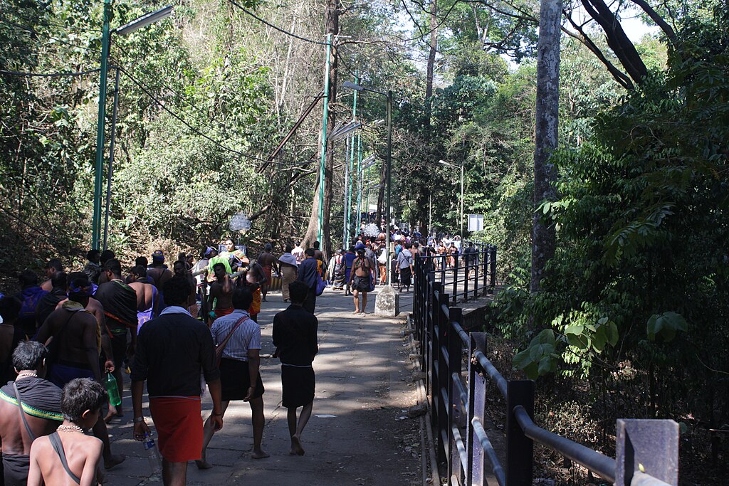 Pilgrims travelling through Sabarimala Pampa pathway